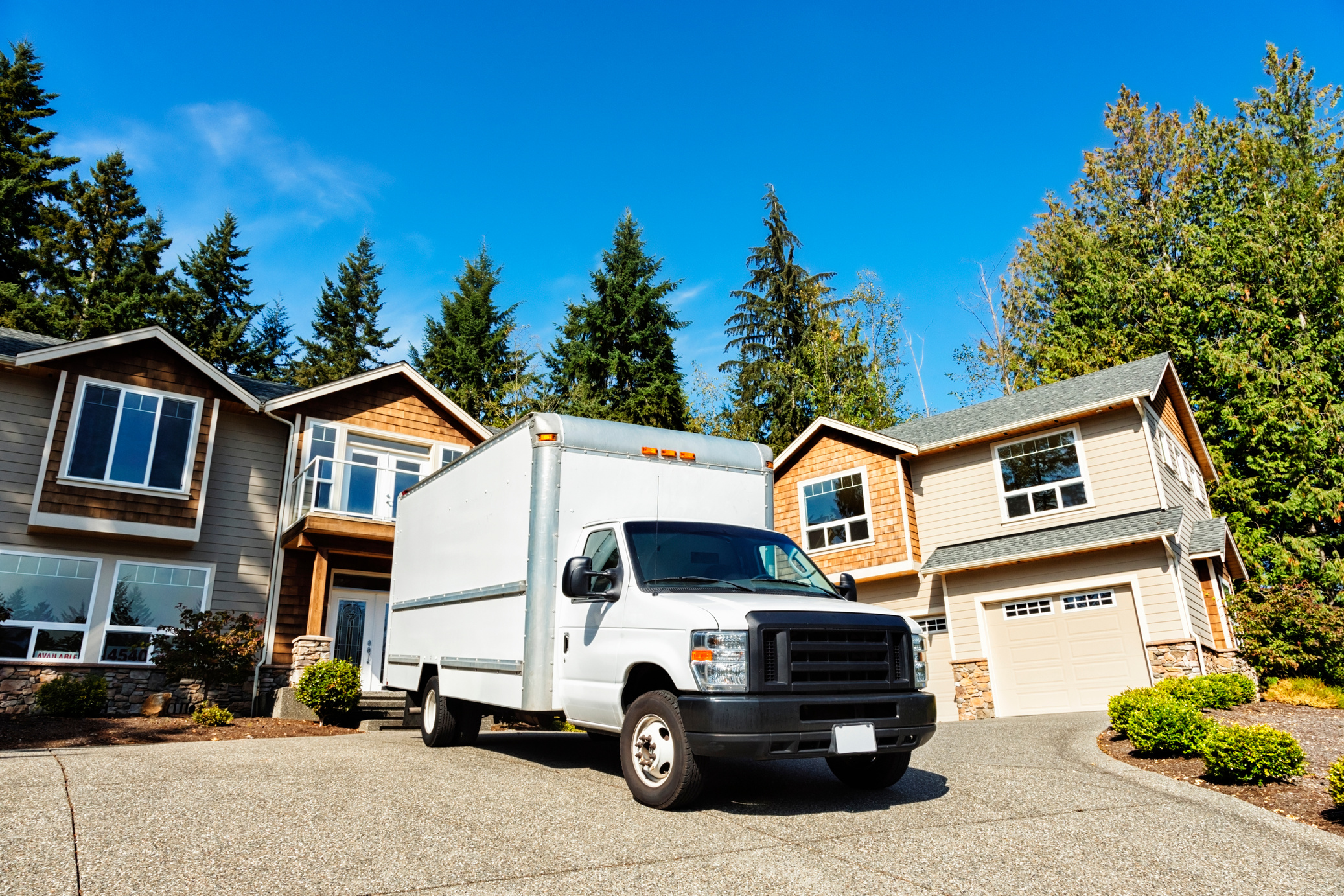 Plain White Moving Truck in Driveway